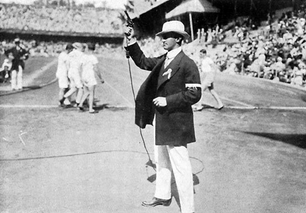 Starter for the track events of 1912, showing the starting pistol connected to the electronic timing system